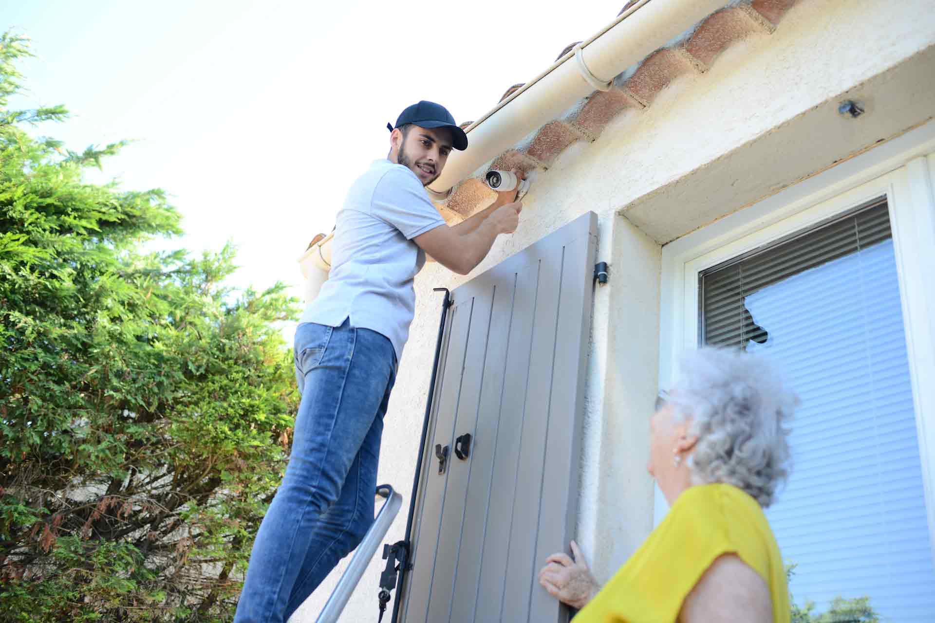 Senior having home security system installed